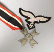 A German WWII War Merit Cross medal and a third reich badge