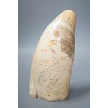 A 19th century scrimshaw whale tooth, 16cm
