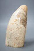 A 19th century scrimshaw whale tooth, 16cm