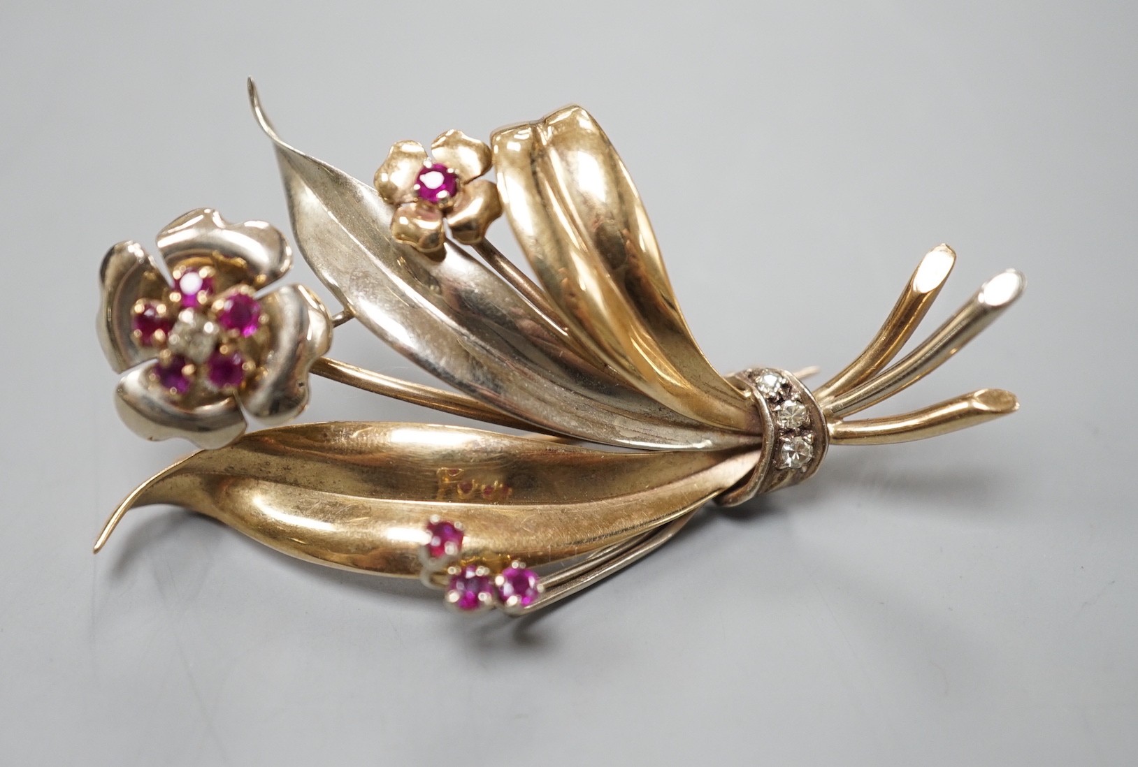 A two colour yellow metal, ruby and diamond cluster set floral spray brooch, 51mm, gross weight 8. - Image 4 of 4