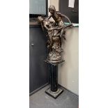 A bronzed metal group of a dancing couple on associated wood plinth combined height 170cm