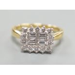 A 750 yellow metal, baguette and round cut diamond set rectangular cluster ring, size M, gross