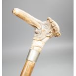A novelty carved stag horn handled cane, of a large nosed gent, 78cms long