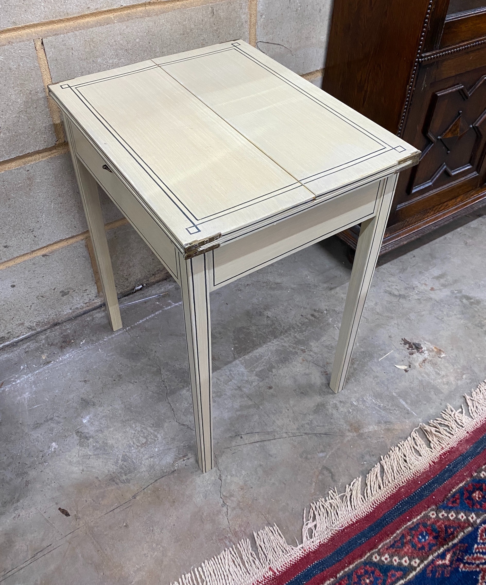 A painted side table with hinged twin flap top, width 39cm, depth 50cm, height 63cm