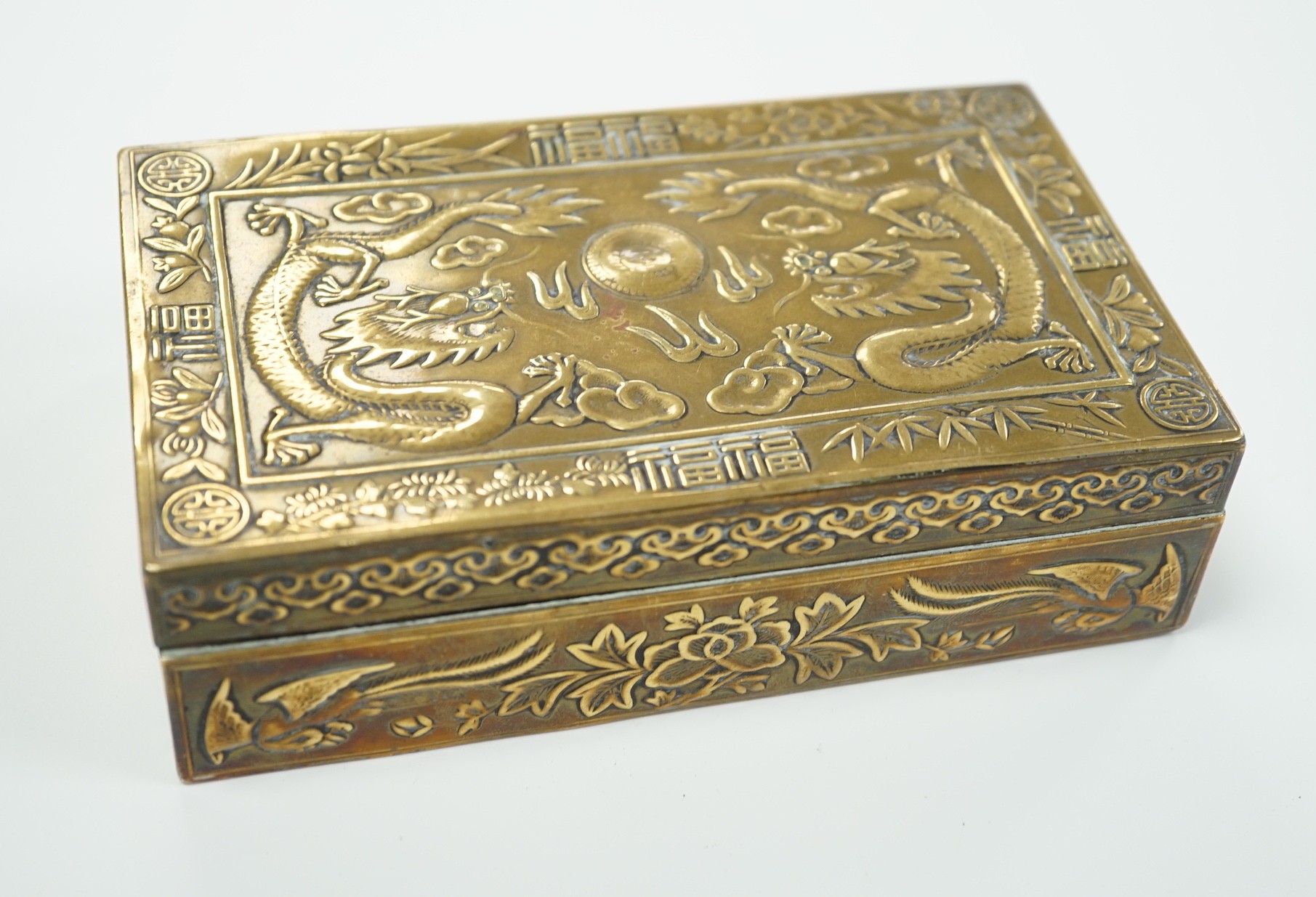 A Chinese brass 'dragon' cigarette box, 15.5cm