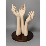 A group of three composite fore-arms on stand, 40 cms high,