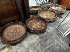 Four chip carved mazers, largest diameter 76cm, and a pair of Afghan stools