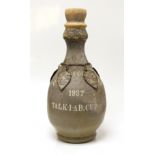 A pottery vase from Fields Polo Club 'The Talk-1-AB Cup', with four white metal badges on a chain