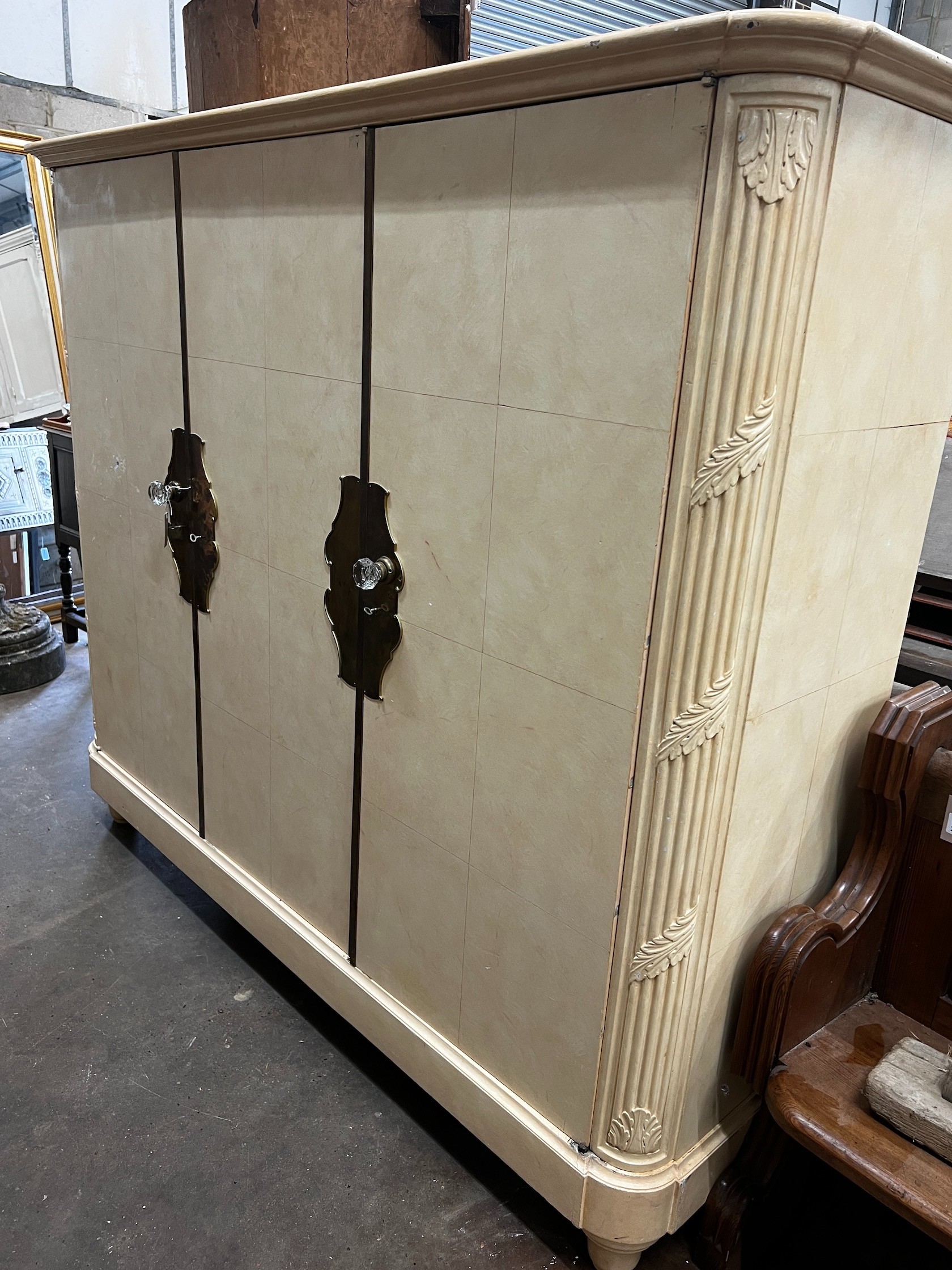 An early 20th century French brass mounted oak compactum wardrobe, width 196cm depth 56cm height