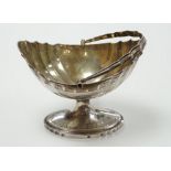 A George III Irish engraved silver bats wing oval shaped pedestal sugar basket, by Richard Sawyer,