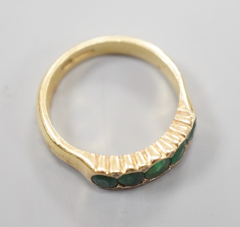 A modern 18ct gold and graduated five stone emerald set half hoop ring, with diamond chip spacers, - Image 4 of 4