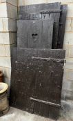 Four assorted Victorian and later iron mounted pine doors, larger width 74cm height 186cm
