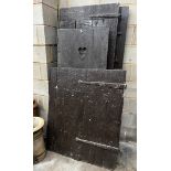 Four assorted Victorian and later iron mounted pine doors, larger width 74cm height 186cm