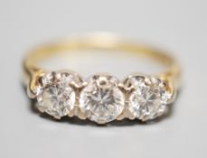 A modern 18ct gold and three stone diamond ring, size L, gross weight 3.3 grams, total diamond