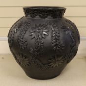 A large black-painted floral decorated terracotta vase, 50cm