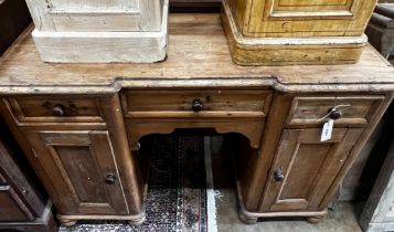A Victorian pine inverse breakfront kneehole desk, width 119cm depth 49cm height 77cm