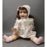 A Heubach Koppelsdorf bisque headed, open mouthed doll, 66cms long
