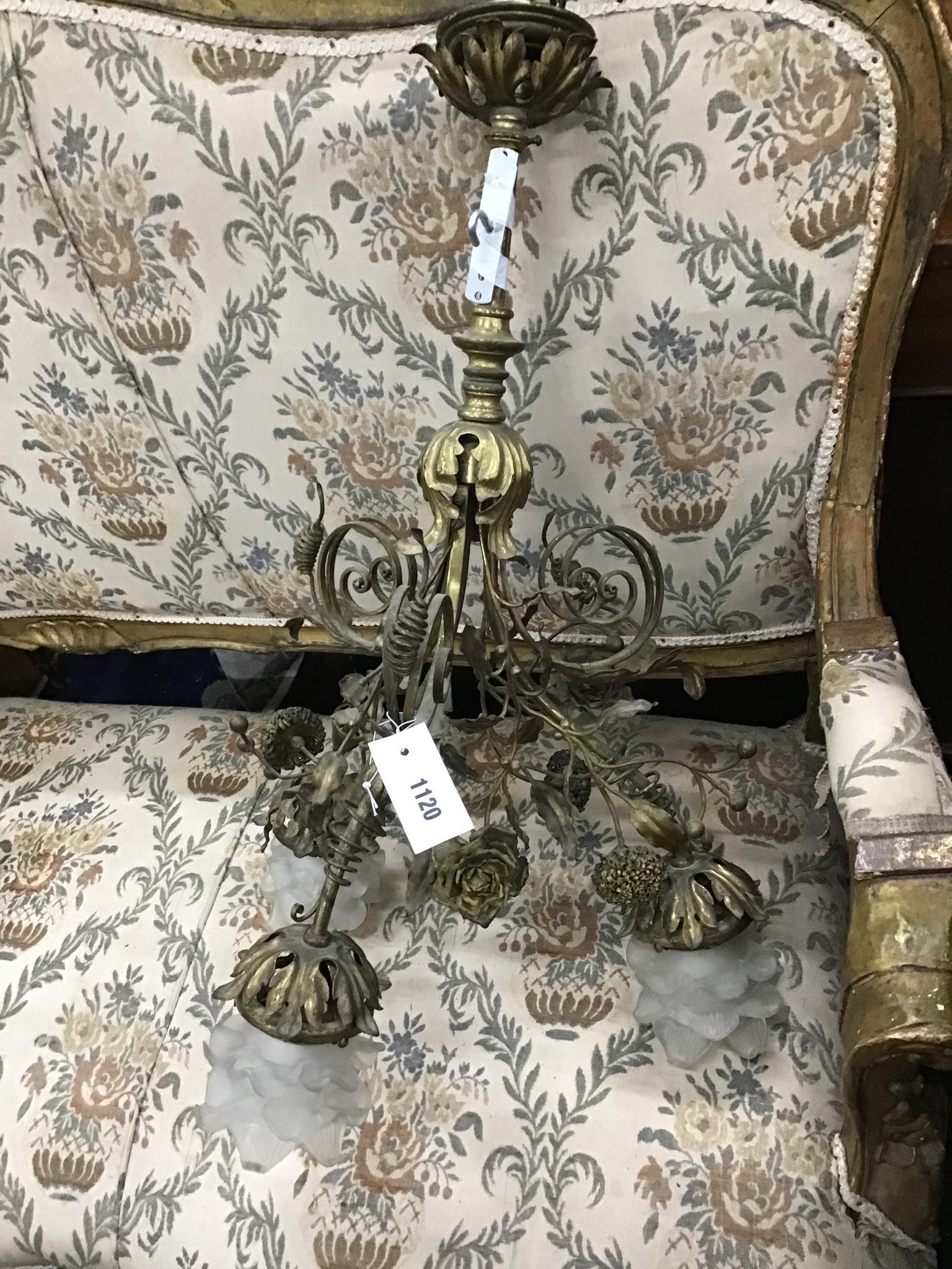 An early 20th century French brass three branch ceiling light with opaque glass shades, height 68cm