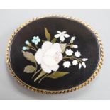 A late Victorian yellow metal mounted pietra dura oval brooch, decorated with a floral spray, 52mm.