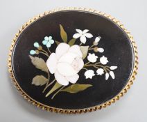 A late Victorian yellow metal mounted pietra dura oval brooch, decorated with a floral spray, 52mm.