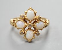 A 1970's 18ct gold, white opal and diamond chip set quatrefoil shaped ring, size O, gross weight 6.1