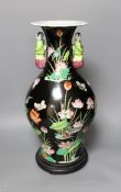 A Chinese famille noire vase, on plinth, 46 cms high,