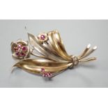 A two colour yellow metal, ruby and diamond cluster set floral spray brooch, 51mm, gross weight 8.