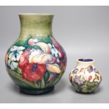 A Moorcroft orchid pattern vase and another smaller vase, orchid vase 19cms high