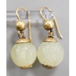 A pair of antique gilt metal and carved hardstone spherical drop earrings, jade diameter 14mm.