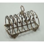 A William IV silver seven bar toastrack, with ring handle, on winged paw feet, Settle & Wilkinson,