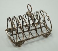 A William IV silver seven bar toastrack, with ring handle, on winged paw feet, Settle & Wilkinson,