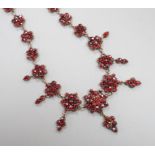 A late Victorian gilt and yellow metal, garnet cluster set drop necklace, 48cm.