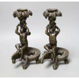 A pair of late 19th century bronze candlesticks modelled as cherubs riding crocodiles, 21.5cm