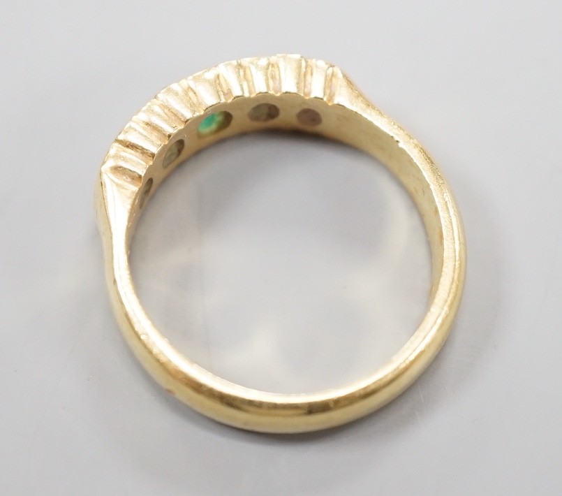 A modern 18ct gold and graduated five stone emerald set half hoop ring, with diamond chip spacers, - Image 3 of 4