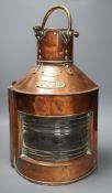 A copper ship’s port lamp, manufactured by Telford.Grier & Mackay, Glasgow, 1918,42 cms high,