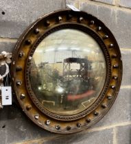 A Regency giltwood convex wall mirror in need of repair, diameter 56cm