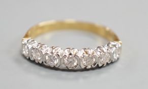 A modern 18ct gold and seven stone diamond set half hoop ring, size T, gross weight 3.9 grams.