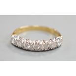 A modern 18ct gold and seven stone diamond set half hoop ring, size T, gross weight 3.9 grams.