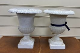 A pair of Victorian cast iron campana shaped garden urns, diameter 24cm, height 30cm
