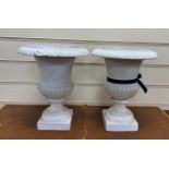 A pair of Victorian cast iron campana shaped garden urns, diameter 24cm, height 30cm