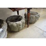A pair of circular reconstituted stone '12 apostles' garden urns diameter 40cm height 28cm