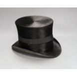 A leather cased Cuthbertson top hat, 19.5x15.5cm