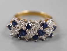 A modern 18ct, sapphire and diamond cluster set half hoop ring, size K, gross weight 5.1 grams.