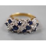 A modern 18ct, sapphire and diamond cluster set half hoop ring, size K, gross weight 5.1 grams.