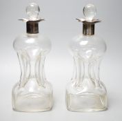 A pair of Edwardian silver mounted hourglass shaped glass decanters with stoppers, by William Hutton