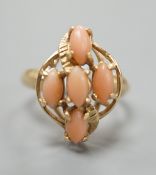 A modern 14k yellow metal and five stone oval coral bead set dress ring, size J/K, gross weight 2.