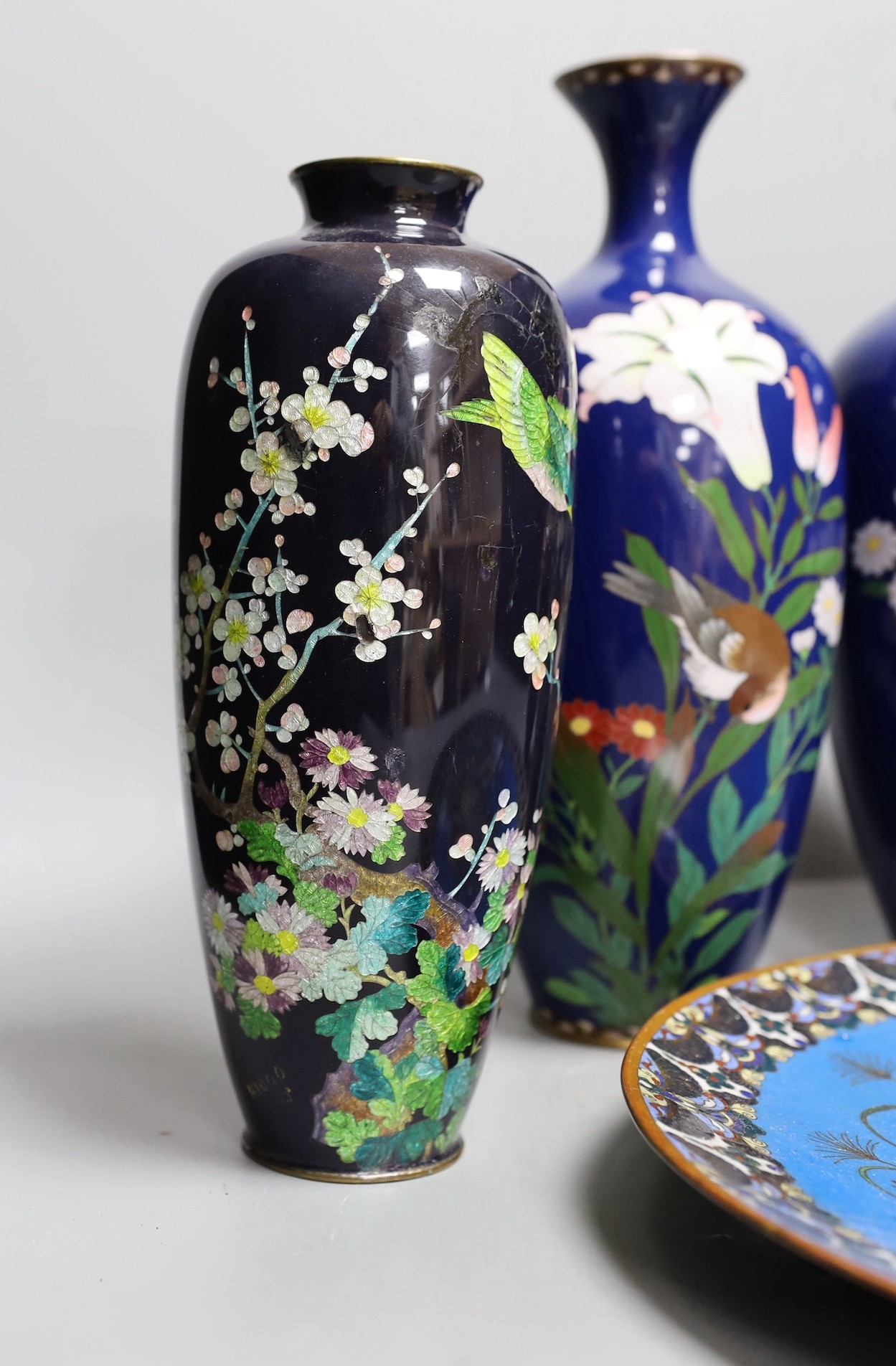 A group of Japanese cloisonné enamel wares to include a pair of vases, two other vases and a dish, - Image 3 of 7