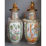 A pair of Chinese Canton famille rose vases, late 19th century, mounted as lamps, total height 43cm