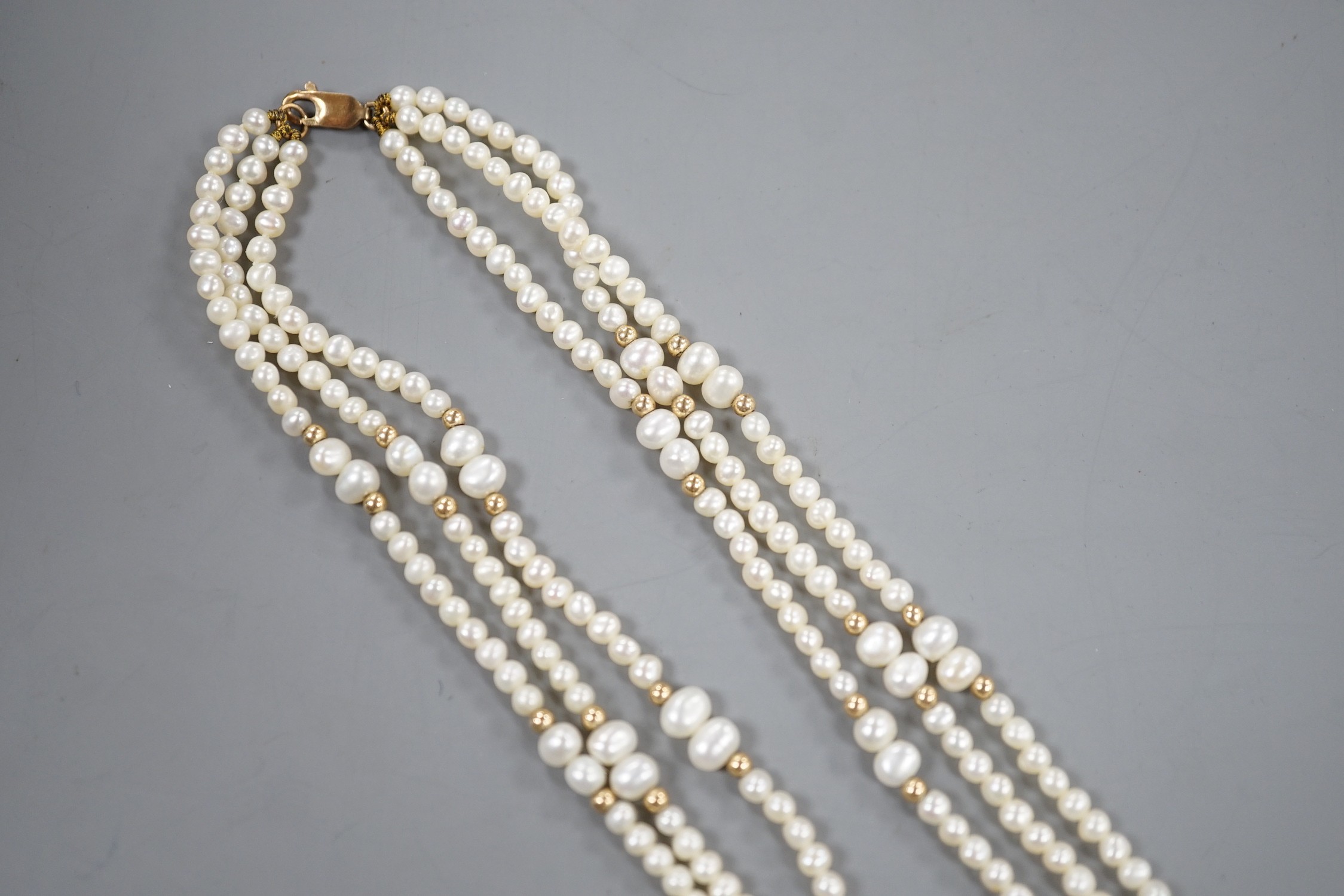 A modern 9k mounted triple strand cultured pearl necklace, 39cm, with yellow metal spacers. - Image 2 of 3
