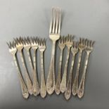 A set of ten Cartier sterling tea forks, 13.4cm and a similar table fork, 9oz.